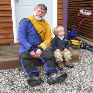 a man sitting on a bench in front of a building