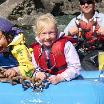 a group of people riding on the back of a boat