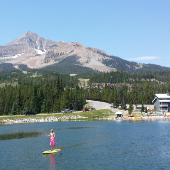 a small boat in a body of water with a mountain in the background