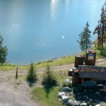 a person sitting on the side of a dirt road