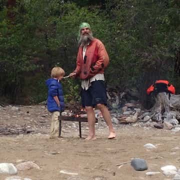 a group of people walking down a dirt road
